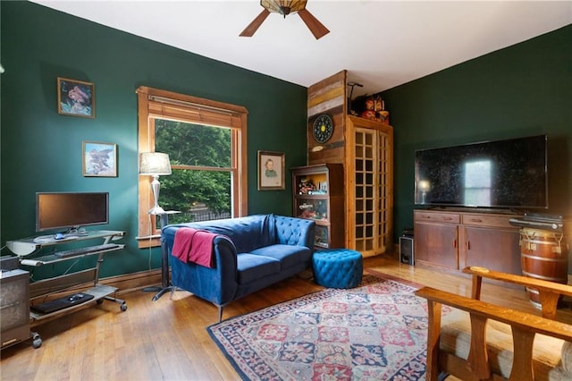 living room with ceiling fan and hardwood / wood-style flooring