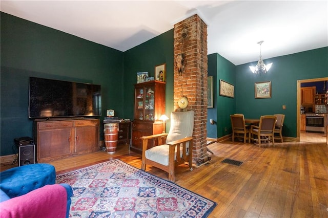 sitting room featuring a notable chandelier and wood-type flooring