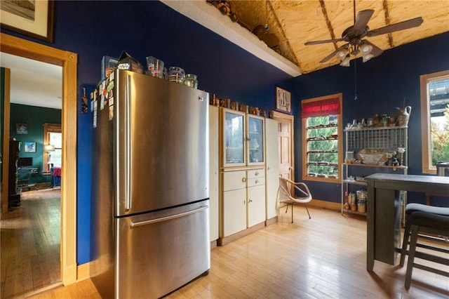 kitchen featuring light wood-type flooring, stainless steel refrigerator, a wealth of natural light, and ceiling fan