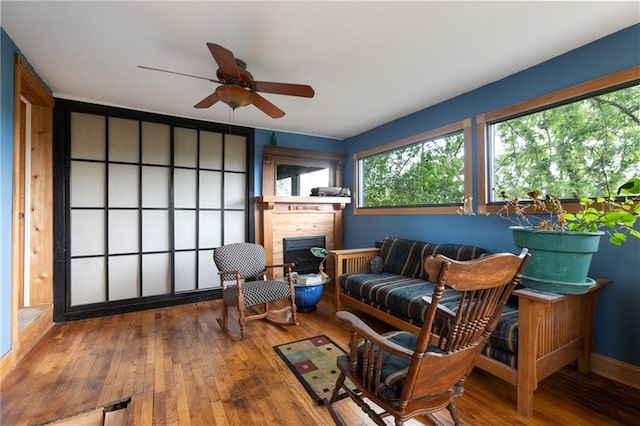 living area with ceiling fan and hardwood / wood-style floors