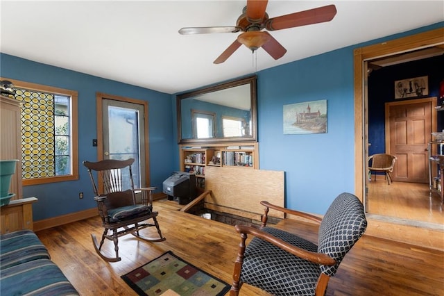 sitting room with ceiling fan and light hardwood / wood-style flooring