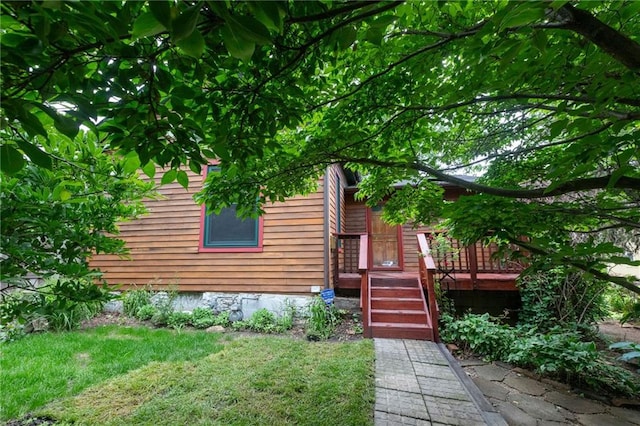 exterior space featuring a yard and a wooden deck