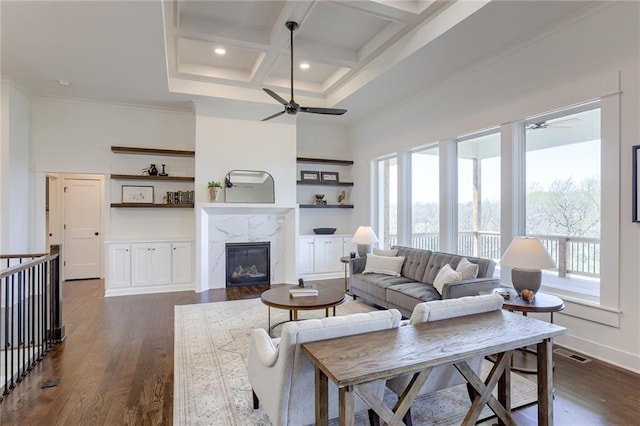 12300 S Hastings St, Olathe, KS 66061 - living room featuring a ceiling fan, healthy amount of natural light, a towering ceiling, coffered ceiling, and a high end fireplace
