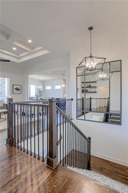 12300 S Hastings St, Olathe, KS 66061 - staircase with a chandelier, coffered ceiling, wood finished floors, recessed lighting, and beamed ceiling