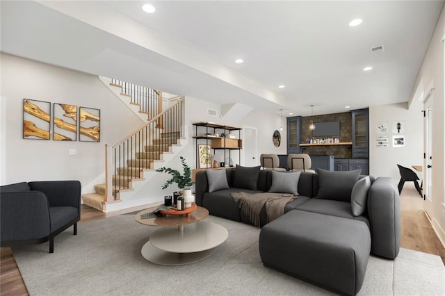 12300 S Hastings St, Olathe, KS 66061 - living area featuring wood finished floors, stairway, and recessed lighting