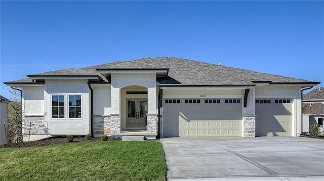 12300 S Hastings St, Olathe, KS 66061 - prairie-style house featuring an attached garage, stone siding, driveway, and stucco siding