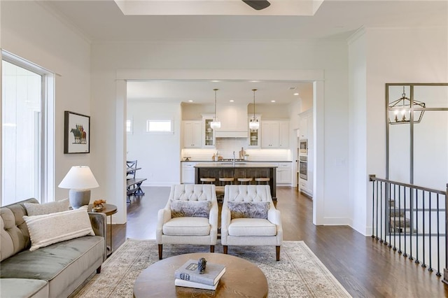 12300 S Hastings St, Olathe, KS 66061 - living area featuring dark wood-style floors, crown molding, and a chandelier
