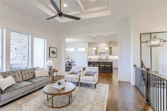 12300 S Hastings St, Olathe, KS 66061 - living area with dark wood finished floors, a ceiling fan, coffered ceiling, a chandelier, and recessed lighting