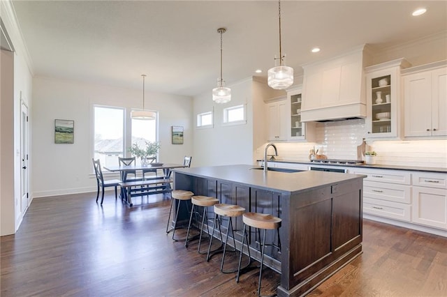 12300 S Hastings St, Olathe, KS 66061 - kitchen with tasteful backsplash, a breakfast bar, recessed lighting, dark wood finished floors, and ornamental molding