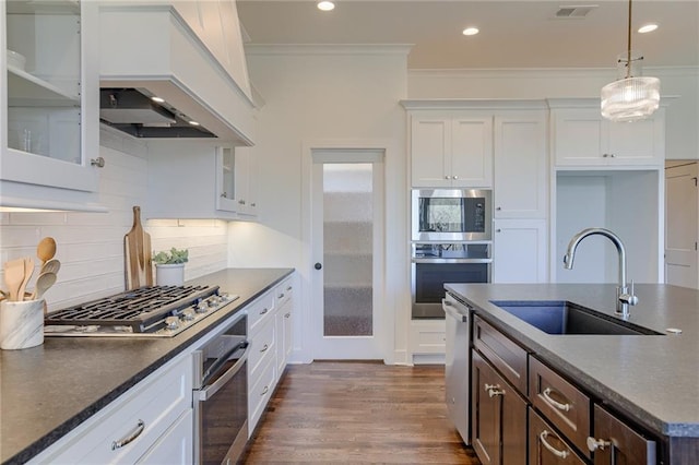 12300 S Hastings St, Olathe, KS 66061 - kitchen featuring appliances with stainless steel finishes, dark countertops, ornamental molding, white cabinetry, and glass insert cabinets