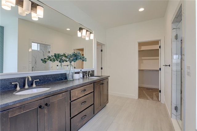12300 S Hastings St, Olathe, KS 66061 - bathroom featuring a marble finish shower, double vanity, recessed lighting, and a walk in closet