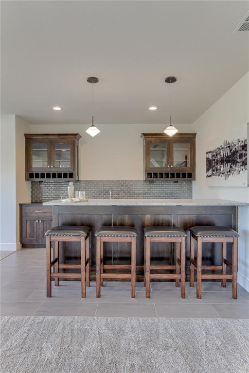 12300 S Hastings St, Olathe, KS 66061 - kitchen featuring light tile patterned floors, backsplash, glass insert cabinets, and recessed lighting