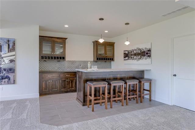 12300 S Hastings St, Olathe, KS 66061 - bar featuring decorative backsplash, pendant lighting, light colored carpet, light tile patterned floors, and recessed lighting