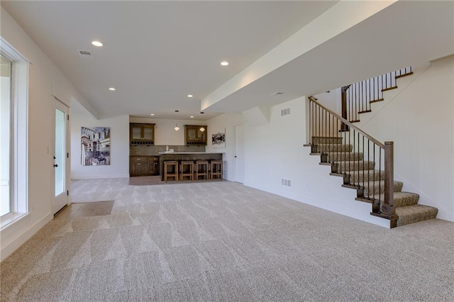 12300 S Hastings St, Olathe, KS 66061 - unfurnished living room featuring light carpet, stairway, and recessed lighting