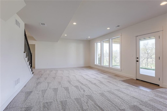 12300 S Hastings St, Olathe, KS 66061 - unfurnished living room featuring healthy amount of natural light, recessed lighting, stairs, and light colored carpet