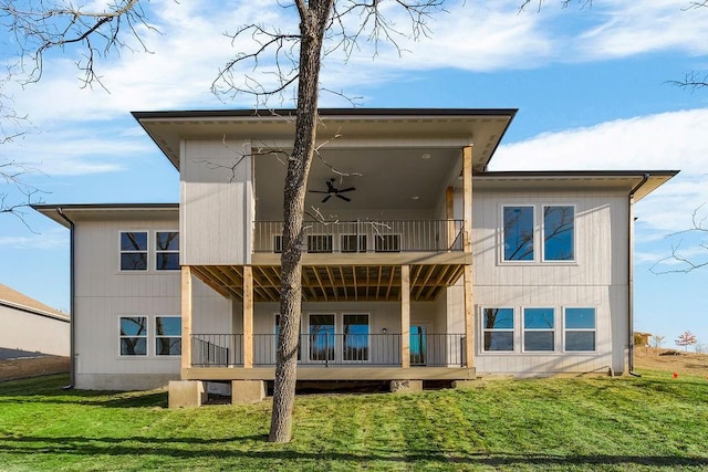 back of house with a yard and a balcony