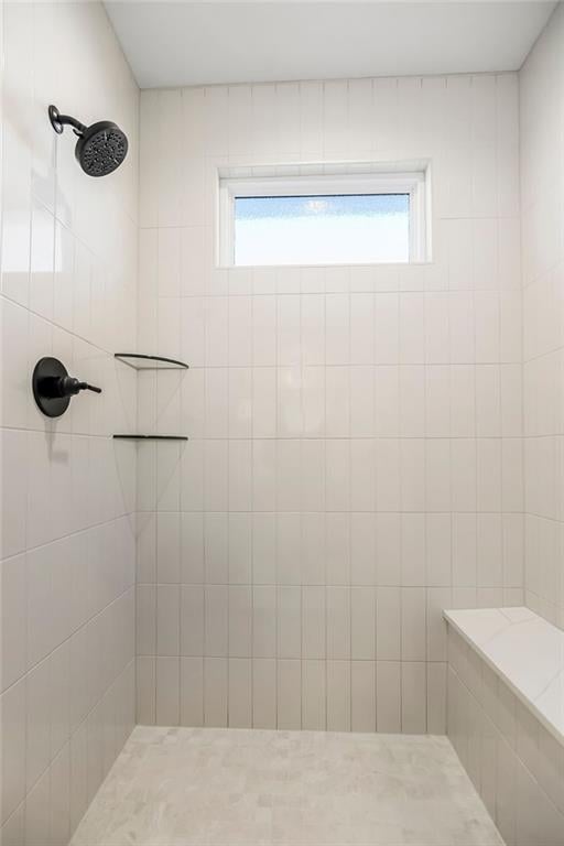 bathroom featuring tiled shower