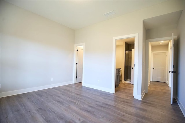 unfurnished bedroom featuring dark hardwood / wood-style floors