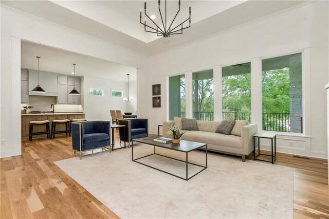 12484 S Barth Rd, Olathe, KS 66061 - living area featuring a chandelier, light wood-style floors, and a high ceiling