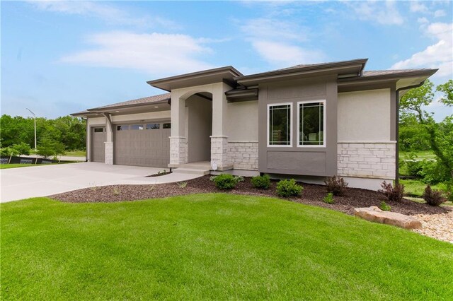 12484 S Barth Rd, Olathe, KS 66061 - prairie-style house featuring stone siding, an attached garage, and stucco siding