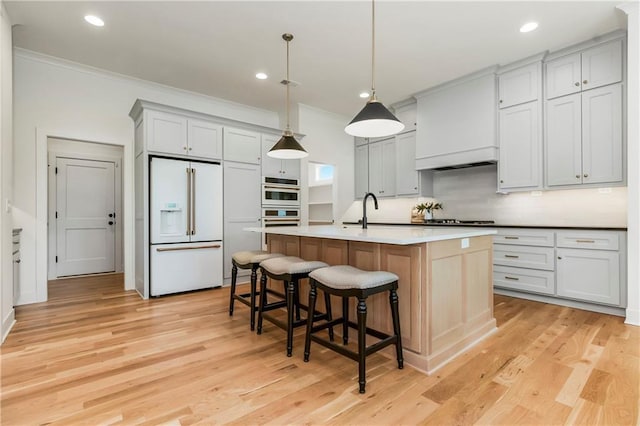 12484 S Barth Rd, Olathe, KS 66061 - kitchen featuring high end white fridge, ornamental molding, recessed lighting, decorative backsplash, and light wood finished floors