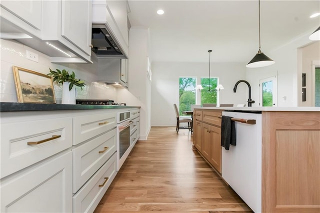 12484 S Barth Rd, Olathe, KS 66061 - kitchen featuring white appliances, custom exhaust hood, tasteful backsplash, light wood-type flooring, and recessed lighting