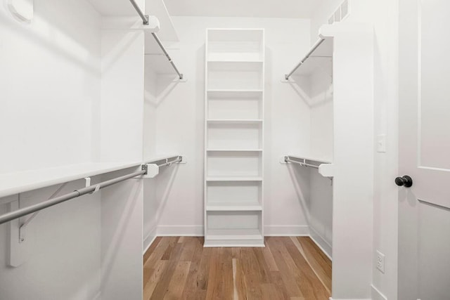 12484 S Barth Rd, Olathe, KS 66061 - walk in closet featuring wood finished floors