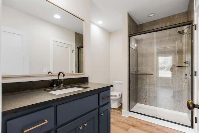 12484 S Barth Rd, Olathe, KS 66061 - bathroom with vanity, wood finished floors, and a stall shower