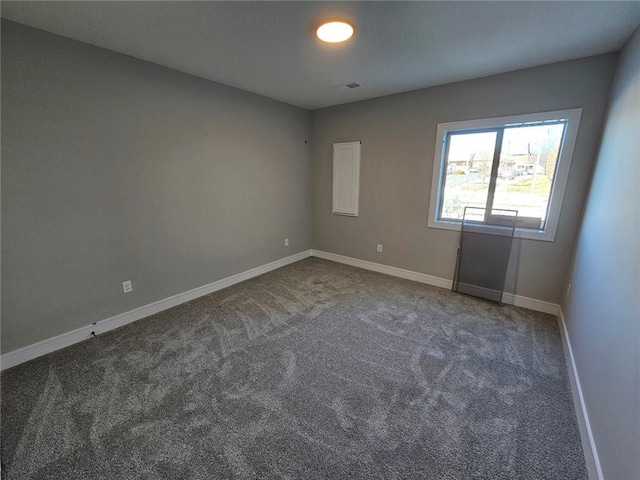 empty room with dark carpet