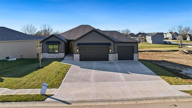 view of front of house with a front yard and a garage