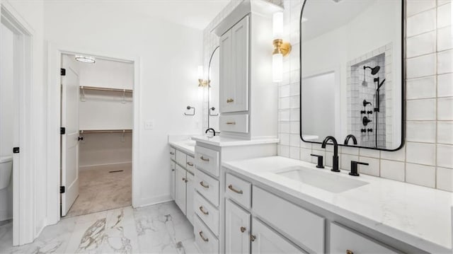 bathroom with decorative backsplash, vanity, toilet, and walk in shower