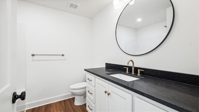 bathroom featuring vanity, toilet, and wood-type flooring