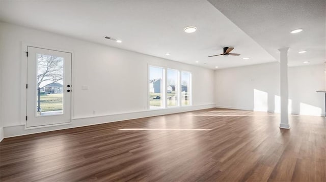 interior space with dark hardwood / wood-style floors, ceiling fan, and a healthy amount of sunlight