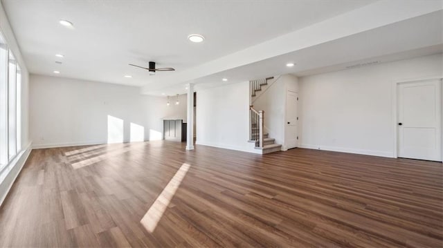 unfurnished living room with ceiling fan and dark hardwood / wood-style flooring