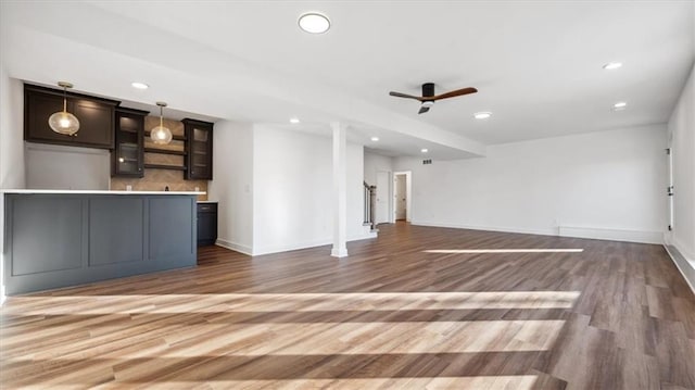 unfurnished living room with ceiling fan and wood-type flooring