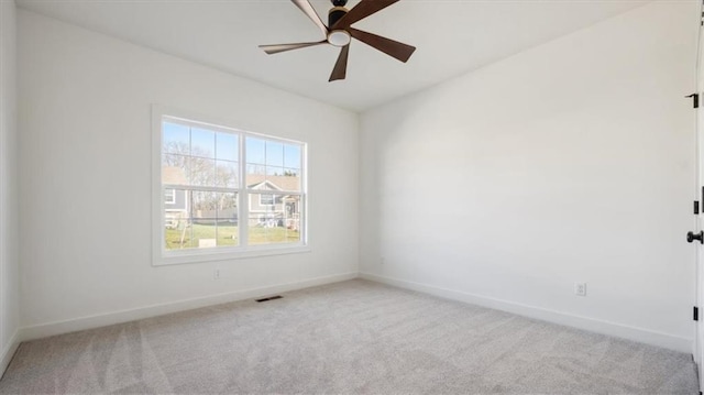 carpeted empty room featuring ceiling fan