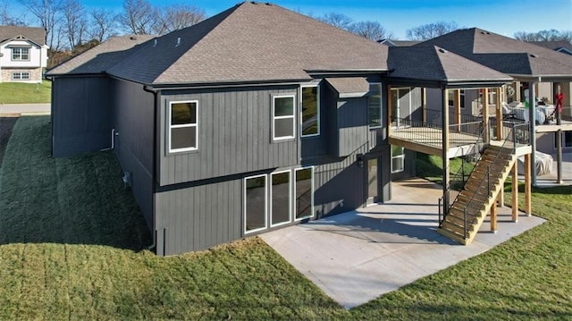 back of house with a patio area and a lawn