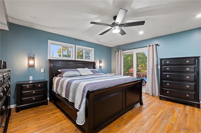 bedroom with multiple windows, ceiling fan, and light hardwood / wood-style flooring