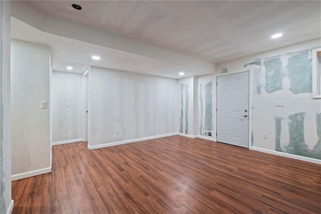 basement with dark hardwood / wood-style floors