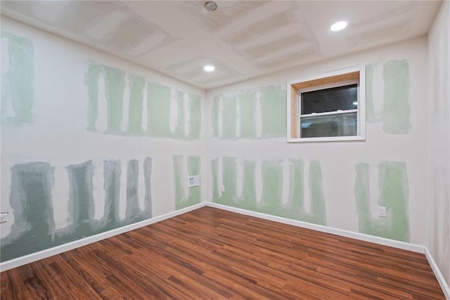 unfurnished room with hardwood / wood-style flooring