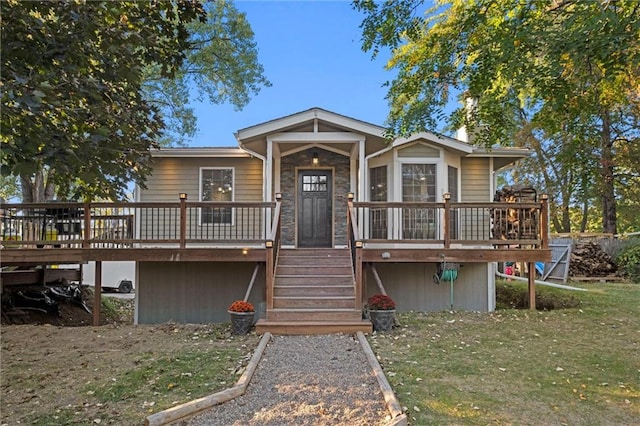 view of front of home featuring a front lawn and a wooden deck