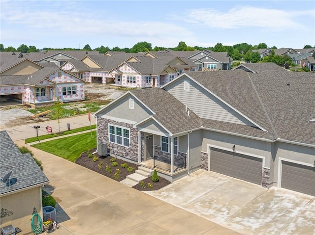 view of front of home with central AC unit and a garage