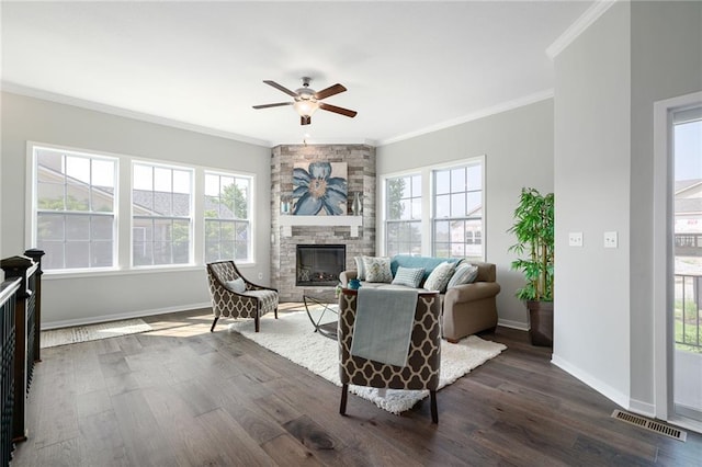 living room featuring a wealth of natural light, a fireplace, and dark hardwood / wood-style flooring