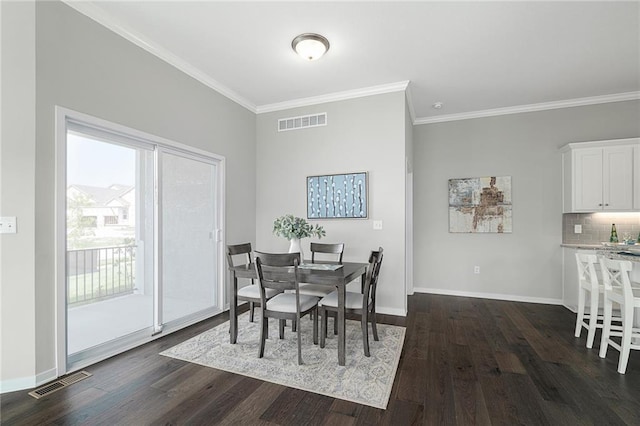 dining room featuring crown molding and dark wood-type flooring