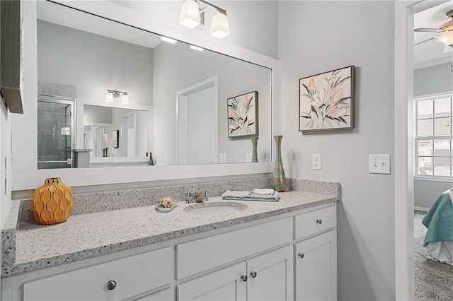 bathroom with ceiling fan, vanity, and an enclosed shower