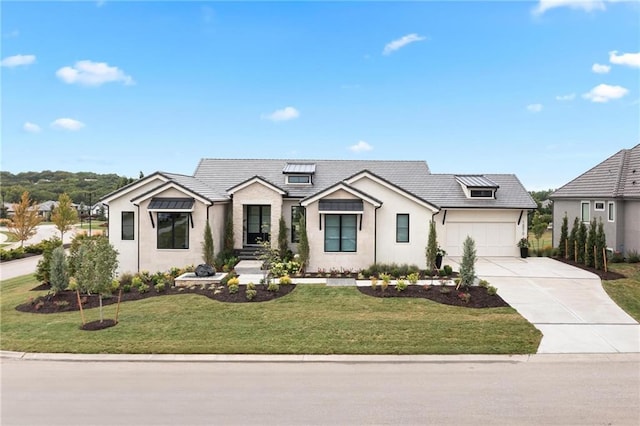 modern farmhouse style home featuring a garage, concrete driveway, a standing seam roof, and a front yard