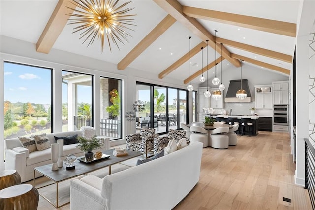 living room with an inviting chandelier, high vaulted ceiling, beamed ceiling, and light hardwood / wood-style floors