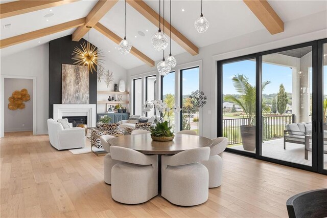 dining area featuring high vaulted ceiling, light hardwood / wood-style flooring, beamed ceiling, and an inviting chandelier