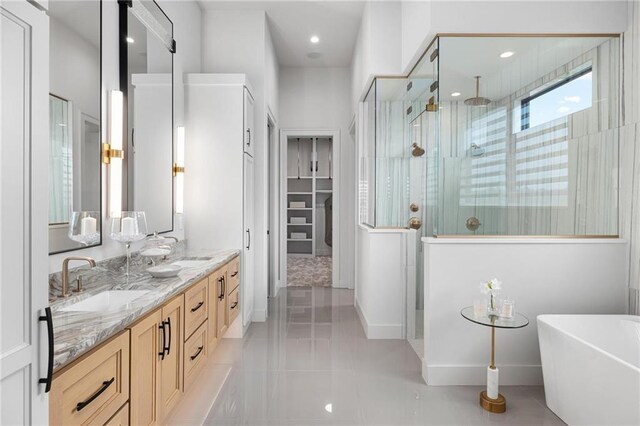 bathroom featuring dual vanity, plus walk in shower, and tile patterned flooring