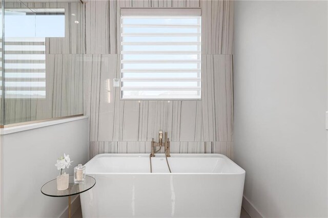 bathroom featuring a tub to relax in